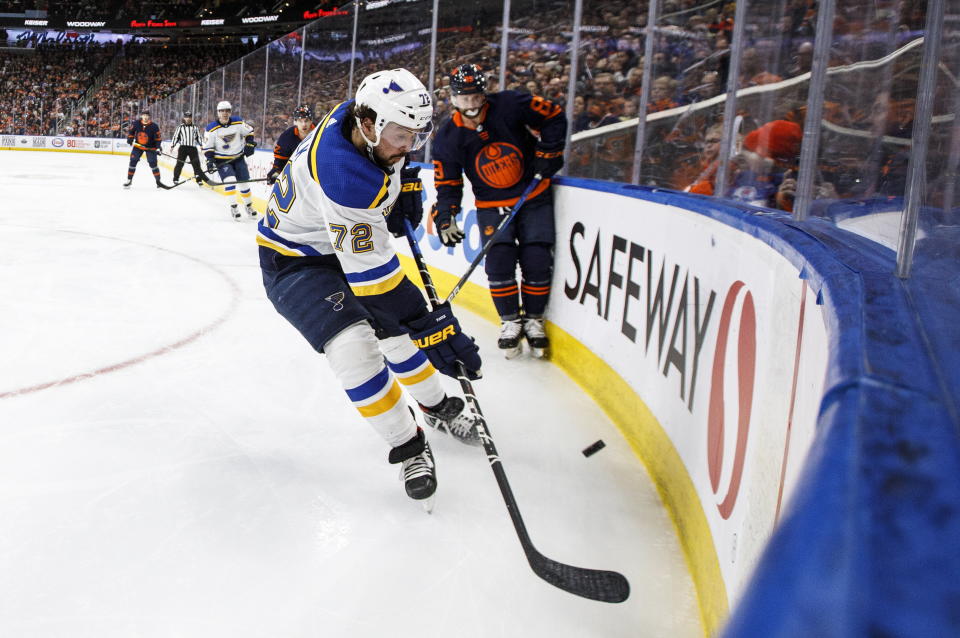 St. Louis Blues' Justin Faulk (72) and Edmonton Oilers' Sam Gagner (89) battle for the puck during the second period of an NHL hockey game Friday, Jan. 31, 2020, in Edmonton, Alberta. (Jason Franson/The Canadian Press via AP)