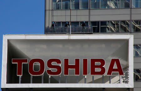 FILE PHOTO: The logo of Toshiba Corp is seen as window cleaners work on the company's headquarters in Tokyo, Japan, February 14, 2017. REUTERS/Toru Hanai/File Photo