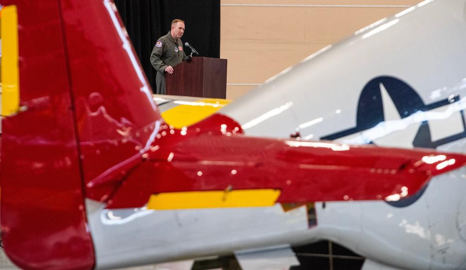 Col. Brian Vaughn, 187th Fighter Wing Commander, is seen over the red tail of a P-51 fighter as he speaks during the F-35A Lightning II Aircraft Arrival ceremony at the 187th Fighter Wing at Dannelly Field in Montgomery, Ala., on Friday morning February 9, 2024.