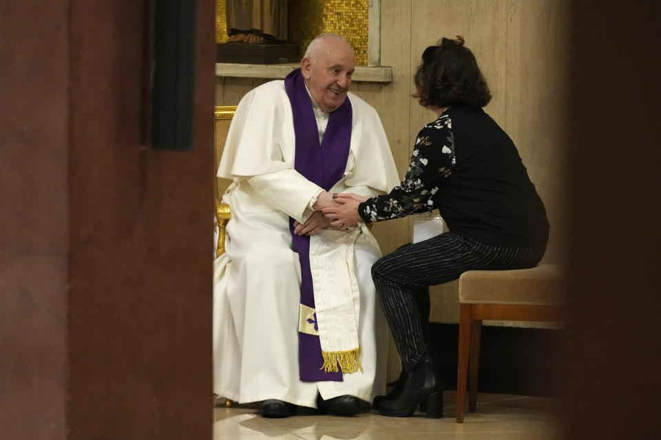 Pope Francis confesses a woman as he visits the parish church of St. Pius V for the "24 hours for the Lord" Lenten initiative of prayer and reconciliation, in Rome, Friday, March 8, 2024. The event will be celebrated in dioceses around the world on the eve of the fourth Sunday of Lent, from Friday 8 to Saturday 9 March.(AP Photo/Andrew Medichini)