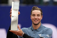 Jan-Lennard Struff of Germany lifts the winner's trophy after the final match against Taylor Fritz of the United States at the Tennis ATP tournament in Munich, Germany, Sunday, April 21, 2024. (AP Photo/Matthias Schrader)