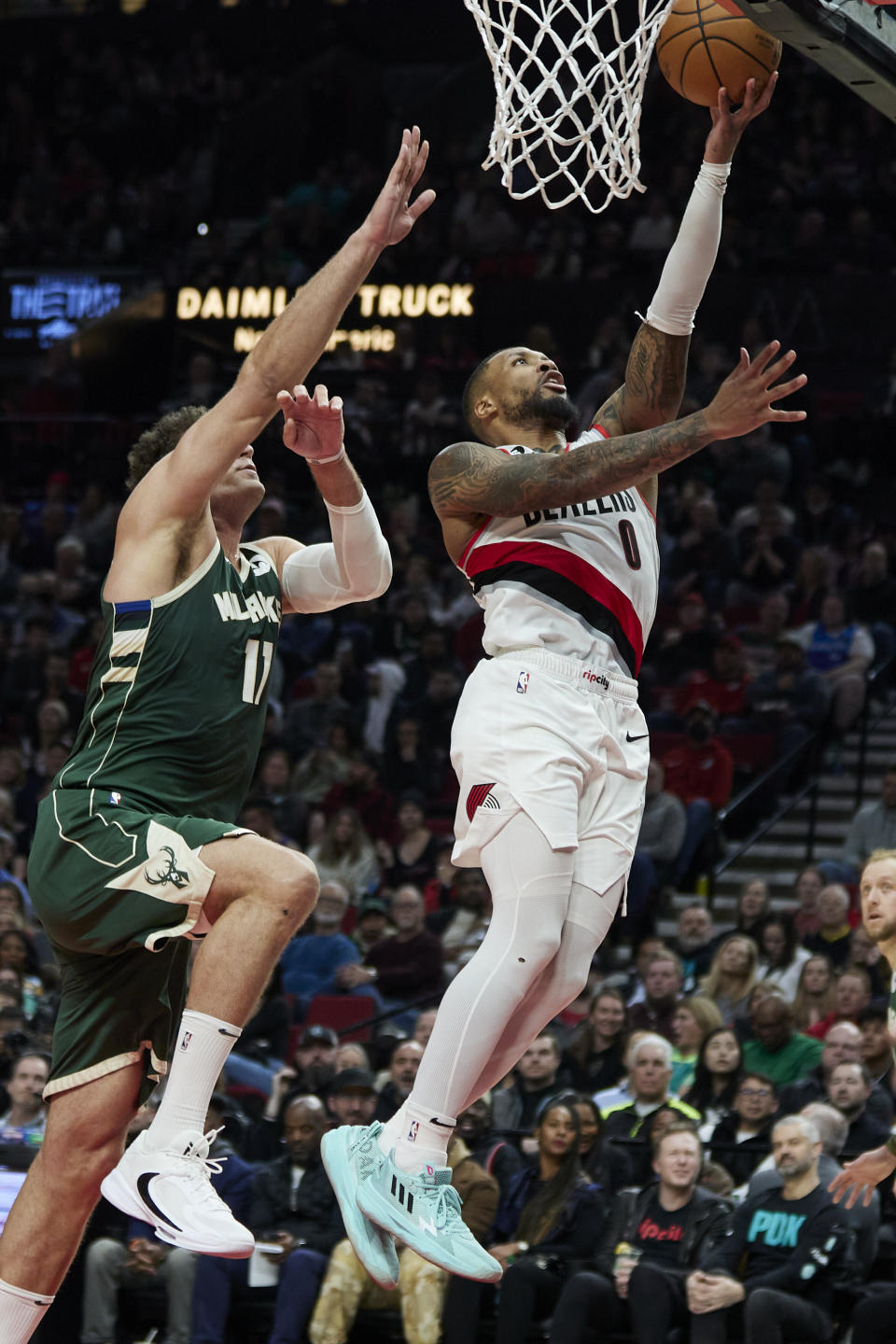 Portland Trail Blazers guard Damian Lillard, right, shoots in front of Milwaukee Bucks center Brook Lopez during the first half of an NBA basketball game in Portland, Ore., Monday, Feb. 6, 2023. (AP Photo/Craig Mitchelldyer)