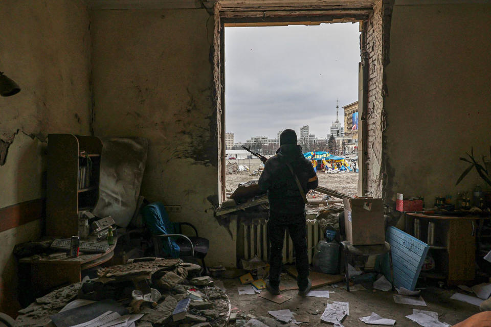 A member of the Territorial Defense Forces stands inside the damaged Kharkiv regional administration building in the aftermath of a shelling in downtown Kharkiv on March 1.<span class="copyright">Sergey Kozlov—EPA-EFE/Shutterstock</span>