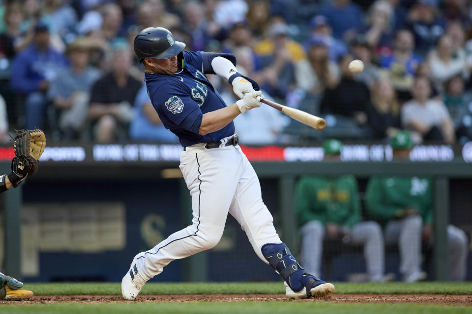 Seattle Mariners' Ty France hits a solo home run off Oakland Athletics reliever Trevor May during the sixth inning of a baseball game Thursday, May 25, 2023, in Seattle. (AP Photo/John Froschauer)