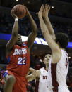 Dayton forward Kendall Pollard (22) shoots against Stanford's Stefan Nastic (4) and Dwight Powell, behind, during the first half in a regional semifinal game at the NCAA college basketball tournament, Thursday, March 27, 2014, in Memphis, Tenn. (AP Photo/Mark Humphrey)
