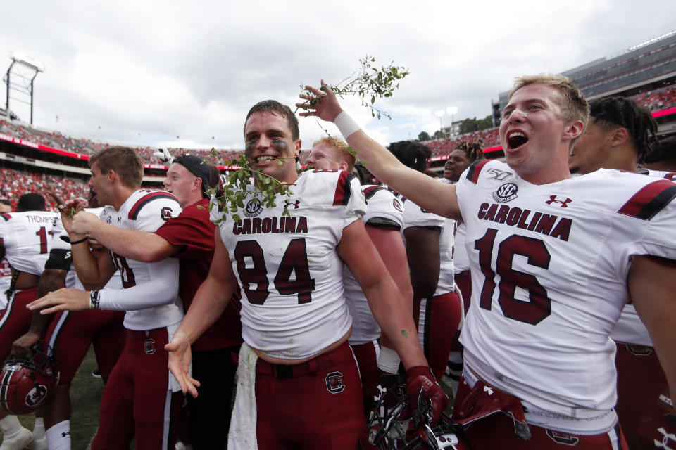 South Carolina's Kyle Markway (84) and Bailey Hart (16) celebrate after defeating Georgia 20-17 in double overtime of an NCAA college football game Saturday, Oct. 12, 2019, in Athens, Ga. (AP Photo/John Bazemore)