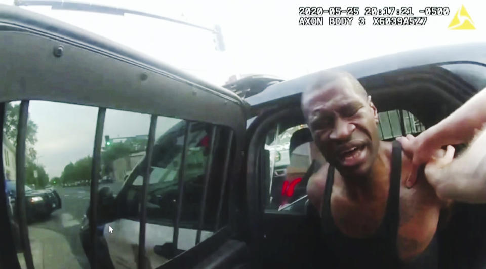 FILE - In this image from police body camera video shown as evidence in court, Minneapolis police officers attempt to place George Floyd in a police vehicle, on May 25, 2020, outside Cup Foods in Minneapolis. Former police Officers Tou Thao, J. Alexander Kueng and Thomas Lane are on trial in federal court accused of violating Floyd's civil rights as fellow Officer Derek Chauvin killed him. (Minneapolis Police Department via AP, File)