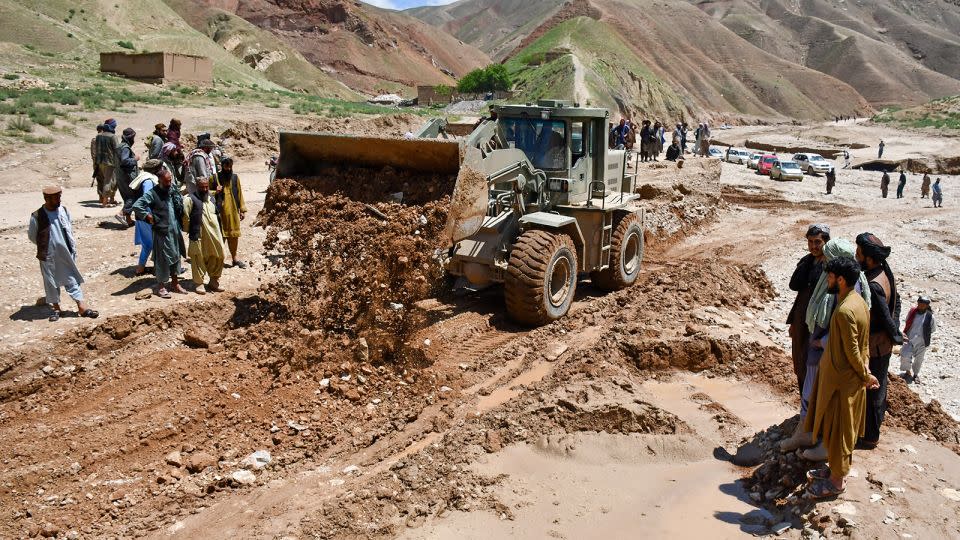 Workers repair a road destroyed by floods in Nahrin district of Baghlan province on May 12, 2024. - Atif Aryan/AFP/Getty Images