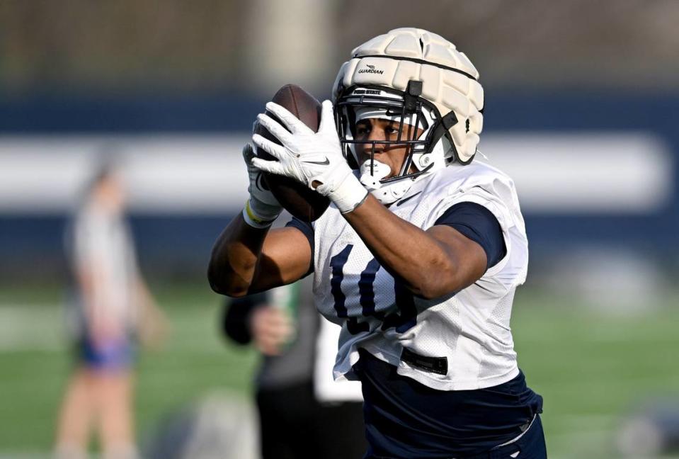 Penn State running back Nick Singleton makes a catch for a drill during spring practice on Tuesday, March 12, 2024.