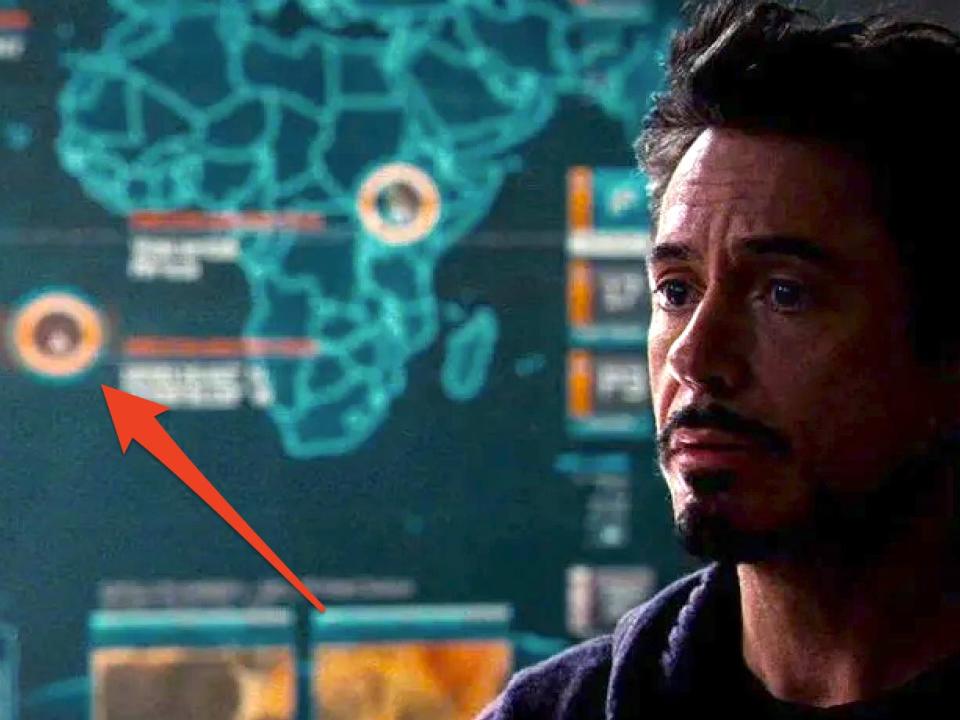 Robert Downey Jr. as Tony Stark stood in front of a map.