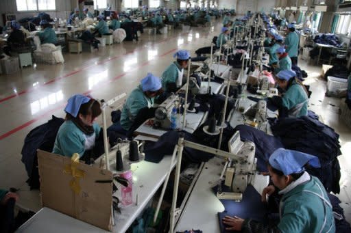 File photo shows workers at a textile factory in Huaibei, Anhui province in China. China's manufacturing activity improved in April but remained in contraction, HSBC said Monday, bolstering the case for the government to give a boost to the world's number two economy