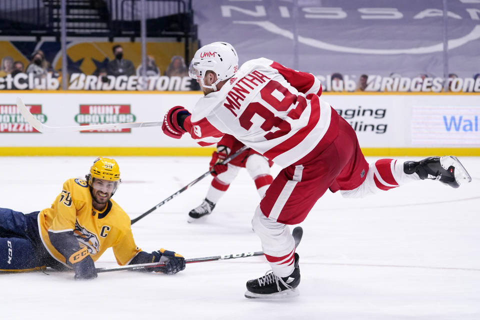 Detroit Red Wings right wing Anthony Mantha (39) shoots past Nashville Predators defenseman Roman Josi (59) to score a goal in the third period of an NHL hockey game Saturday, Feb. 13, 2021, in Nashville, Tenn. The Red Wings won 4-2. (AP Photo/Mark Humphrey)