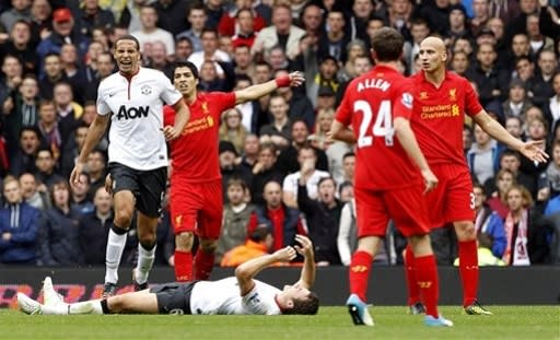 Liverpool's Jonjo Shelvey, right, appeals after his challenge on Manchester United's Jonny Evans during the English Premier League soccer match at Anfield, Liverpool, England,Sunday Sept. 23, 2012. Manchester United won the match 1-2. (AP Photo/PA, Peter Byrne) UNITED KINGDOM OUT NO SALES NO ARCHIVE