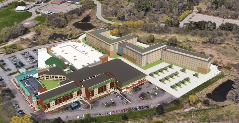 Artist's rendering of Catamount Woods, student housing being built by the University of Vermont and AAM 15 Management LLC, owner of the DoubleTree Hotel on Williston Avenue. The hotel is the building in the foreground and Catamount Woods is the beige building behind it.