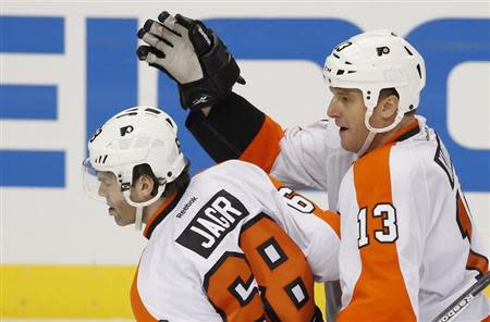 Philadelphia Flyers Jaromir Jagr (L) is congratulated by teammate Pavel Kubina after he scored the game winning goal against the Pittsburgh Penguins during the third period of Game 2 of their NHL Eastern Conference quarter-final hockey game in Pittsburgh, Pennsylvania April 13, 2012. REUTERS/Jason Cohn