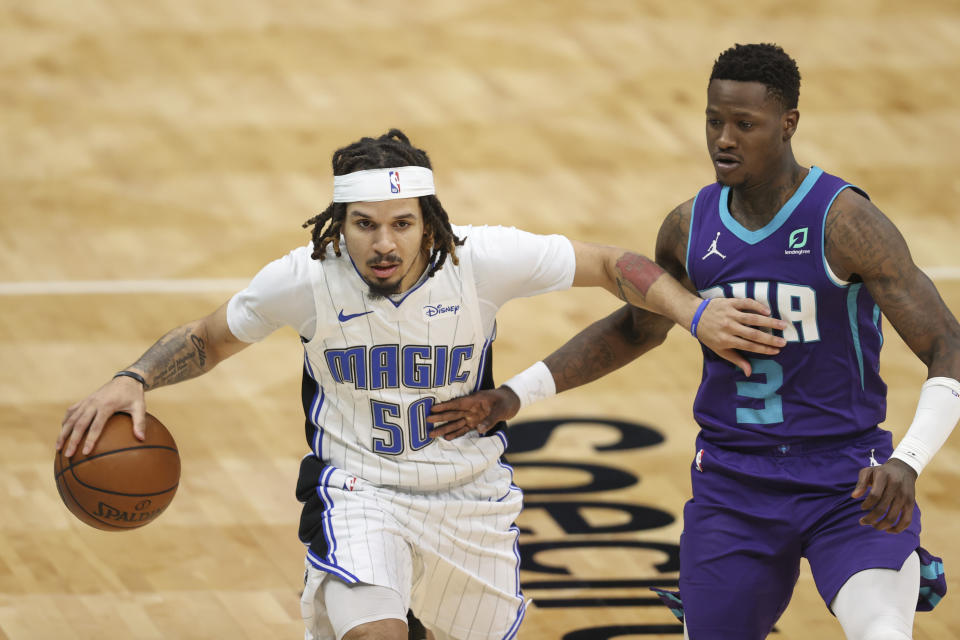 Orlando Magic guard Cole Anthony (50) brings the ball up next to Charlotte Hornets guard Terry Rozier (3) during the second half of an NBA basketball game in Charlotte, N.C., Friday, May 7, 2021. (AP Photo/Nell Redmond)