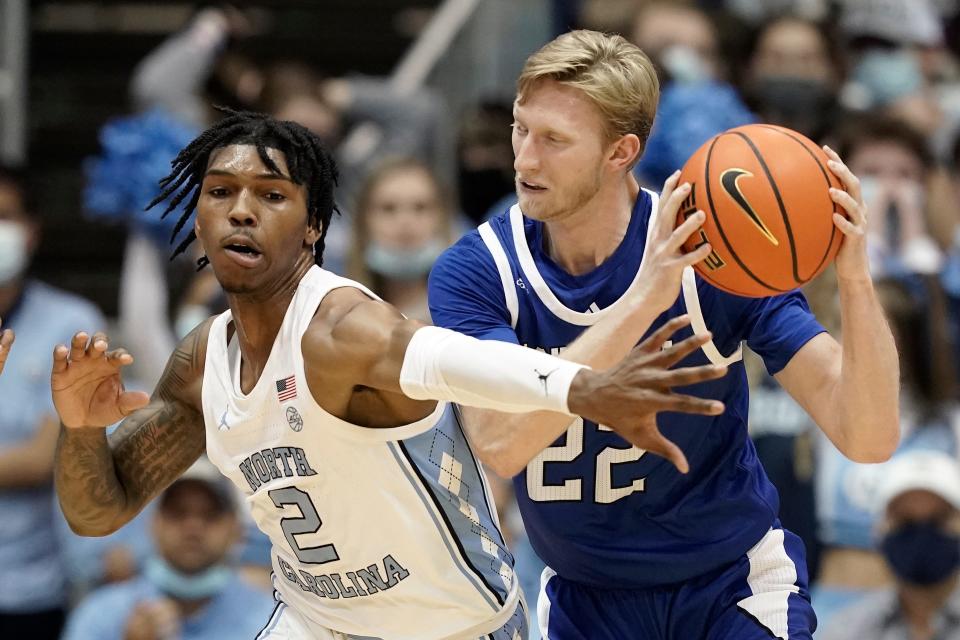 North Carolina guard Caleb Love, left, reaches in and applies defensive pressure against UNC Asheville forward Coty Jude on Tuesday night.