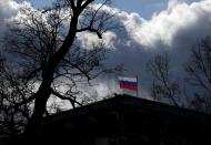 FILE PHOTO: The national flag flutters on top of the Russian embassy in Prague