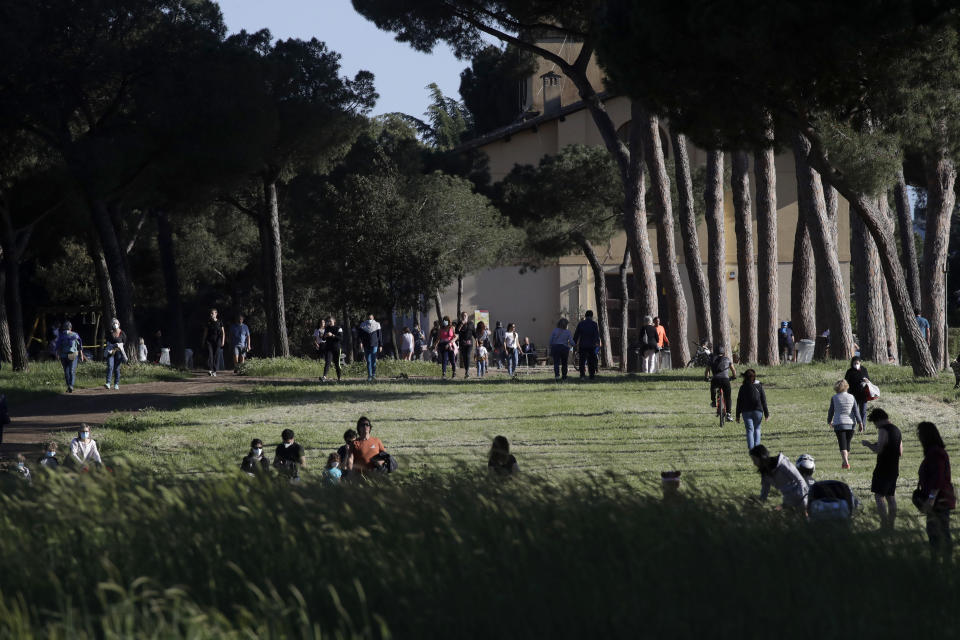 People gather inside Rome's Villa Pamphili park as it reopened after several weeks of closure, part of nationwide limited easing of some lockdown restrictions, on Monday, May 4, 2020. Italy began stirring again Monday after a two-month coronavirus shutdown, with 4.4 million Italians able to return to work and restrictions on movement eased in the first European country to lock down in a bid to stem COVID-19 infections. (AP Photo/Alessandra Tarantino)