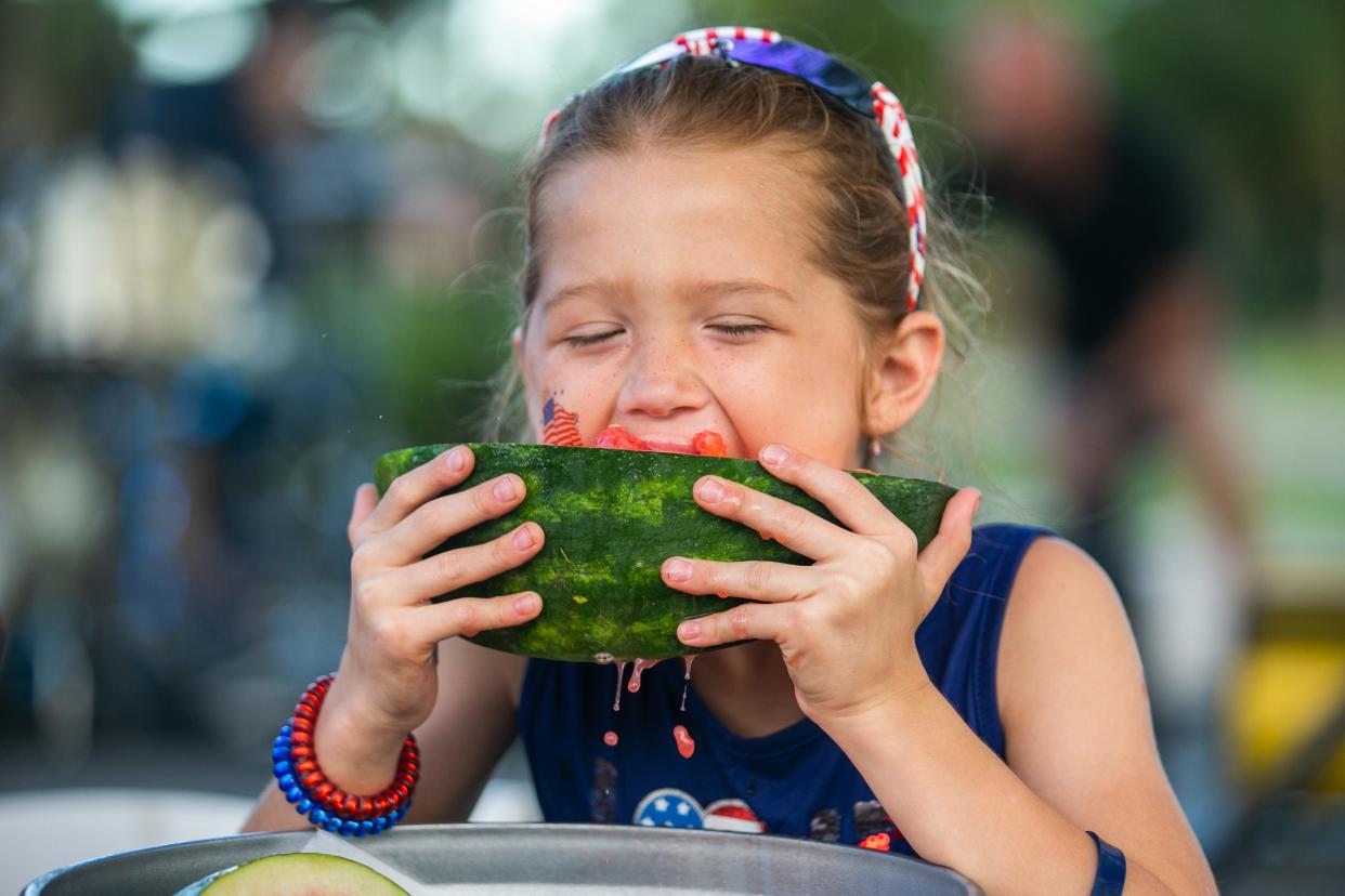 A young watermelon fan takes a bite during a Fourth of July watermelon-eating contest during PGA National Resort's 2022 holiday festivities in Palm Beach Gardens.