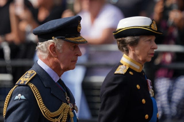 King Charles and the Princess Royal walk behind the coffin of the Queen