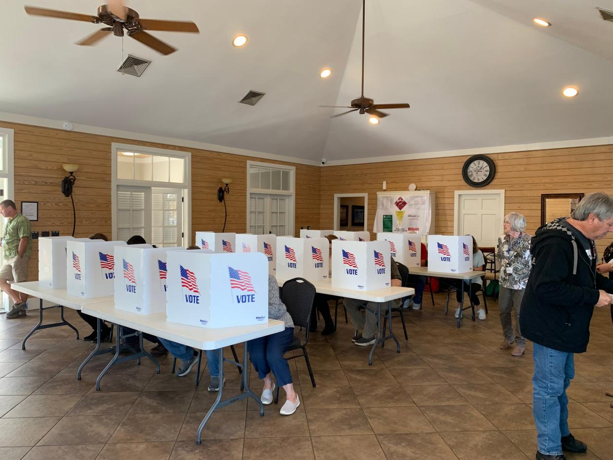 Precinct 210 Poll Manager Ann Price watches over voters in the Lake Caroline Clubhouse in Madison on Nov. 7.