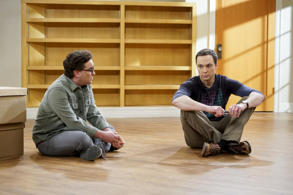 Johnny and Jim sitting on the floor of an empty apartment during a scene from the show