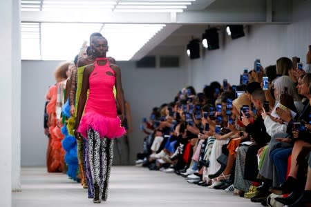 Models present creations during the Mark Fast catwalk show at London Fashion Week in London