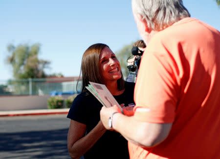 Martha McSally talks to Dennis Williams of Mesa, Arizona as he heads to the polls to vote in the Republican primary for the open U.S. Senate seat, in Mesa, Arizona, U.S. August 28, 2018. REUTERS/Nicole Neri