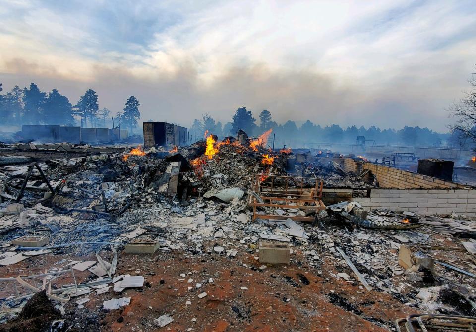 This Wednesday April 20, 2022, photo provided by Bill Wells shows his home on the outskirts of Flagstaff, Ariz., destroyed by a wildfire on Tuesday, April 19, 2022. The wind-whipped wildfire has forced the evacuation of hundreds of homes and animals. (Bill Wells via AP)