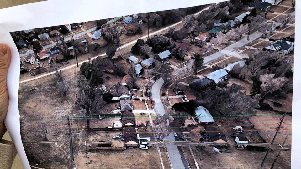 A northeast Wichita resident holds a page from a route map for new Evergy electric lines and towers, which was smuggled out of a neighborhood meeting held by the power company Tuesday. Courtesy photo