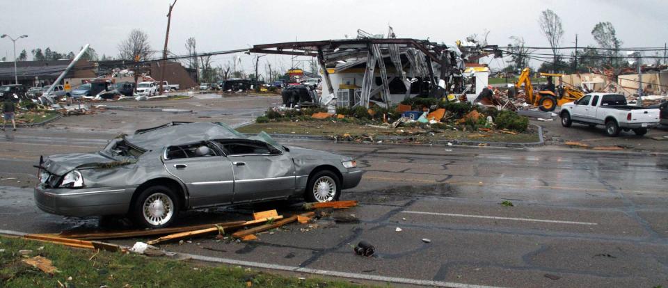 A demolished car sits on North Gloster Street across from what remains of a shell gas station in Tupelo, Miss, after a tornado touched down on Monday, April 28, 2014. At least three tornados flattened homes and businesses, flipped trucks over on highways and injured an unknown number of people in Mississippi and Alabama on Monday as a massive, dangerous storm system passed over several states in the South, threatening additional twisters as well as severe thunderstorms, damaging hail and flash floods. (AP Photo/Jim Lytle)