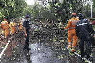 National Disaster Response Force personnel clearing fallen trees from a road in Alibag town of Raigad district following cyclone Nisarga landfall in India's western coast. (Photo by - / National Disaster Response Force (NDRF) / AFP)