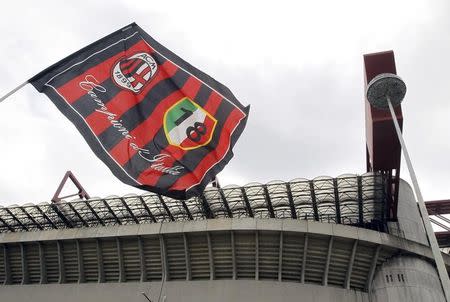 AC Milan's flag waves in front of San Siro stadium in Milan April 29, 2015. REUTERS/Alessandro Garofalo/Files