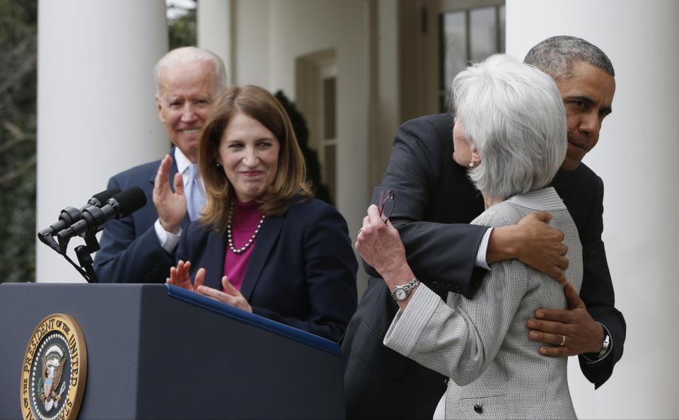 President Obama hugs outgoing Health and Human Services Secretary Kathleen Sebelius, shortly after the first sign-ups of insurance coverage under the so-called Obamacare law, Aprill, 2014. Vice President Joe Biden and Budget Director Sylvia Mathews Burwell look on. (Photo: Charles Dharapak/AP)