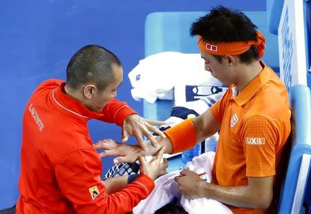 Japan's Kei Nishikori receives treatment during his third round match against Spain's Guillermo Garcia-Lopez at the Australian Open tennis tournament at Melbourne Park, Australia, January 22, 2016. REUTERS/Jason O'Brien