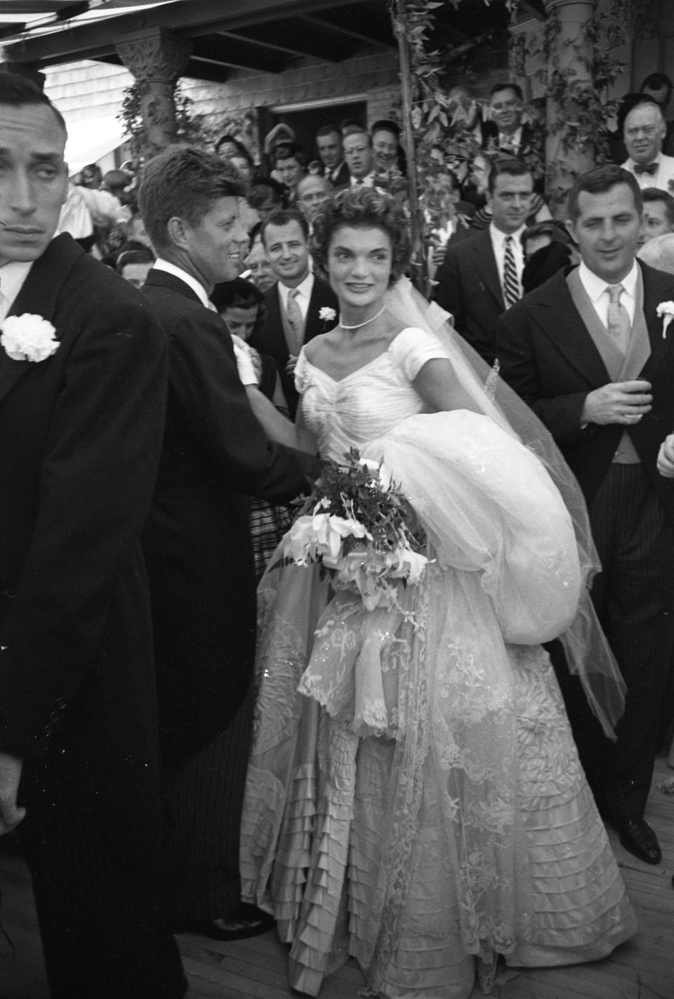 American future First Lady Jacqueline Kennedy (1929 - 1994) poses with her husband politician and future US President John F. Kennedy (1917 - 1963) immediately after their wedding at Hammersmith Farm Newport, Rhode Island, September 12, 1953. (Photo by Lisa Larsen/Time & Life Pictures/Getty Images)