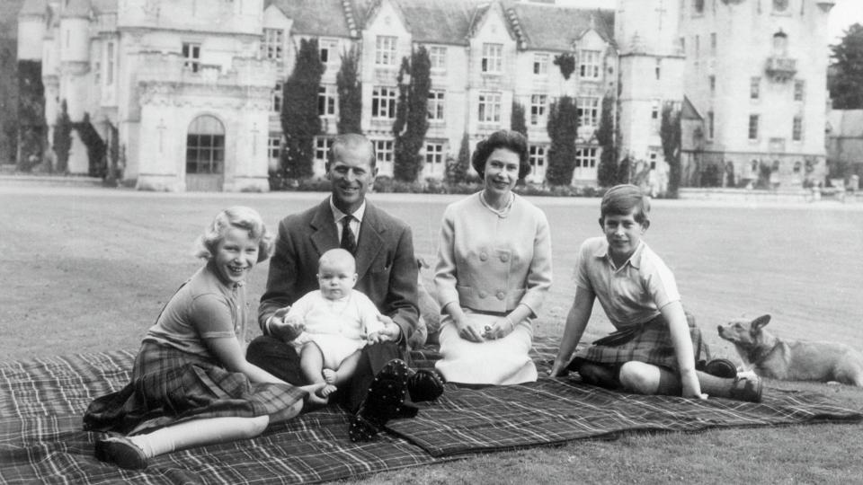 Queen Elizabeth II and Prince Philip, Duke of Edinburgh with their children, Prince Andrew (centre), Princess Anne (left) and Charles, Prince of Wales sitting on a picnic rug outside Balmoral Castle in Scotland, 8th September 1960.