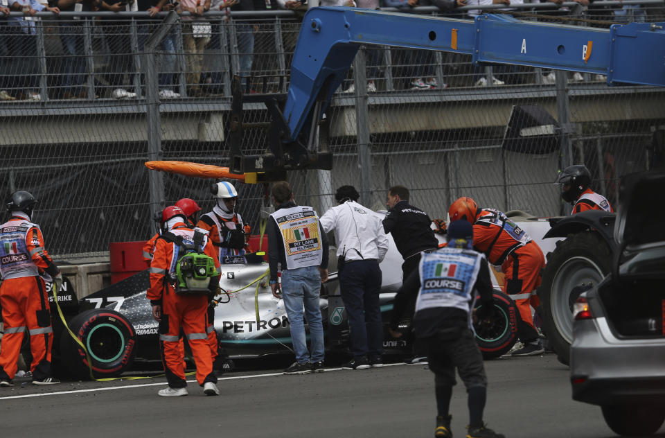 Mercedes driver Valtteri Bottas' car is lifted with a crane after he crashed in a curve during the qualifying session for the Formula One Mexico Grand Prix auto race at the Hermanos Rodriguez racetrack in Mexico City, Saturday, Oct. 26, 2019. (AP Photo/Marco Ugarte)