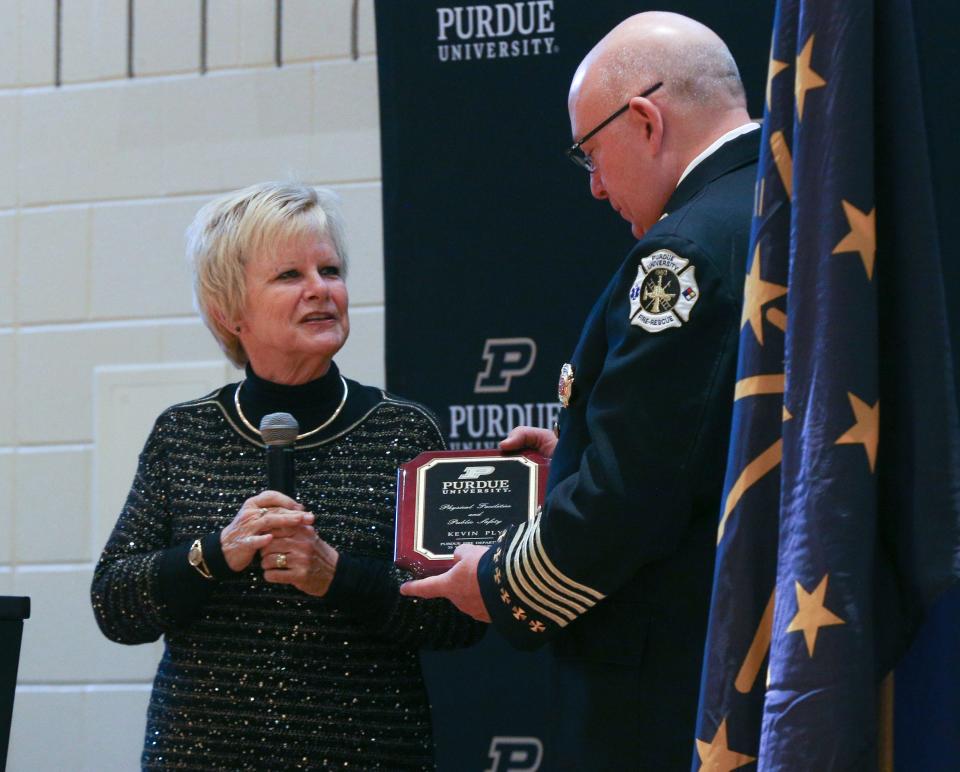 Purdue University Fire Department Retired Fire Chief, Kevin Ply, receives a plaque to honor his time serving as chief during the changing of the guard ceremony, on Wednesday, Dec. 14, 2022, in Lafayette, Ind.