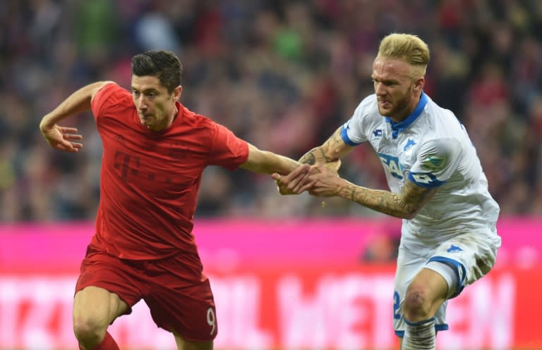 Bayern Munich's Polish forward Robert Lewandowski (L) and Hoffenheim's midfielder Kevin Vogt vie for the ball in Munich, southern Germany, on November 5, 2016