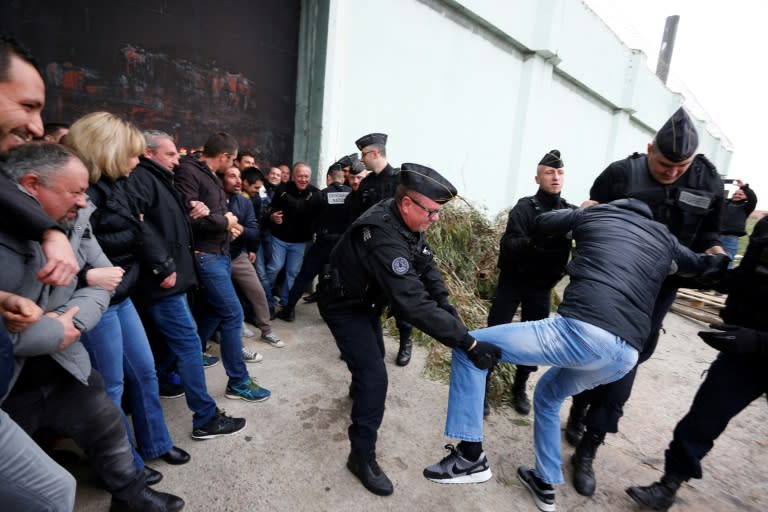 Riot police clash try to move prison guards protesting at Borgo prison on the island of Corsica on Monday