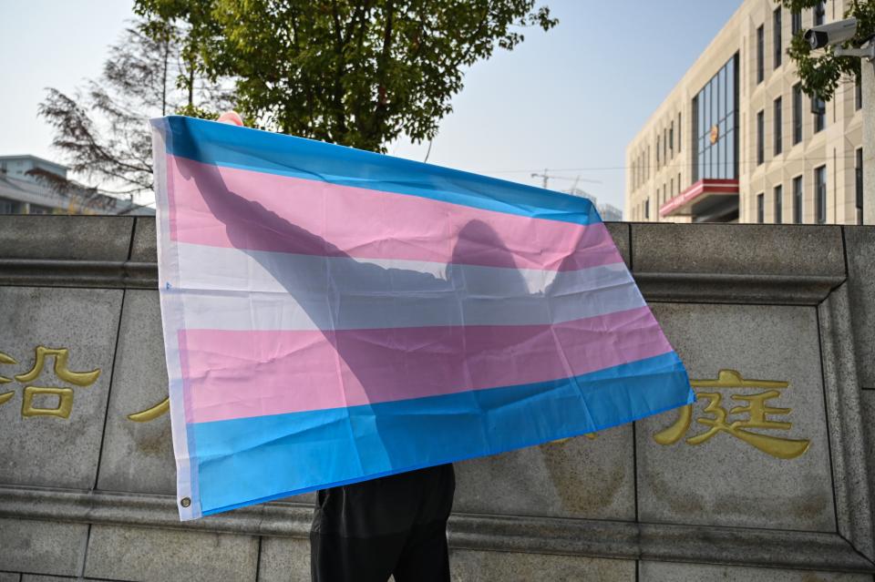 A transgender woman protesting for equal rights holds a transgender pride flag outside the court house in Hangzhou on Dec. 3, 2019.<span class="copyright">Hector Retamal—AFP/Getty Images</span>