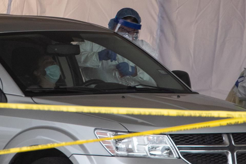 Heath care workers conduct COVID-19 testing at the Corpus Christi's drive-thru testing center at the old Christus Spohn Memorial Hospital parking lot on Friday, April 3, 2020.