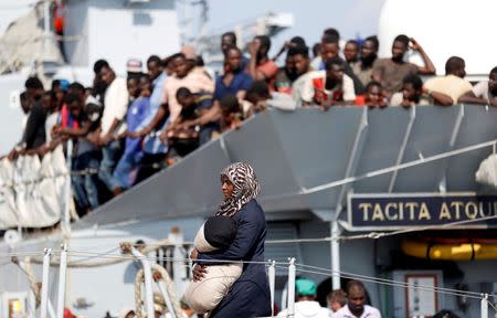 A woman disembarks from the Italian Navy vessel Sfinge in the Sicilian harbour of Pozzallo, southern Italy, August 31, 2016. REUTERS/ Antonio Parrinello