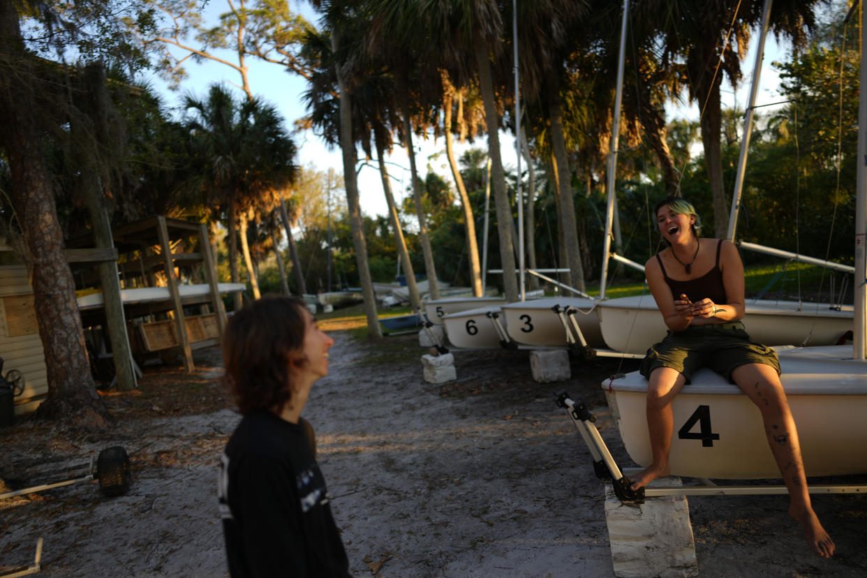 Transfer students Bug Hamnon, right, and Beata Martinez, both of whom started classes at New College of Florida a month earlier and now worry whether they will get the college experience they were seeking, laugh together as they hang out on the school's waterfront, Wednesday, March 1, 2023, in Sarasota, Fla. For years, students have come to this public liberal arts college on the western coast of Florida because they were self-described free thinkers. Now they find themselves caught in the crosshairs of America's culture war. (AP Photo/Rebecca Blackwell)