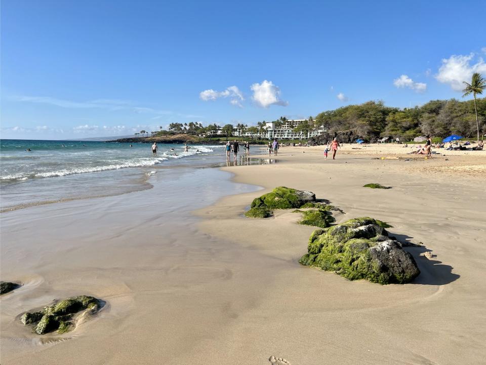 A view of the walk along Hapuna Beach, with sand and water