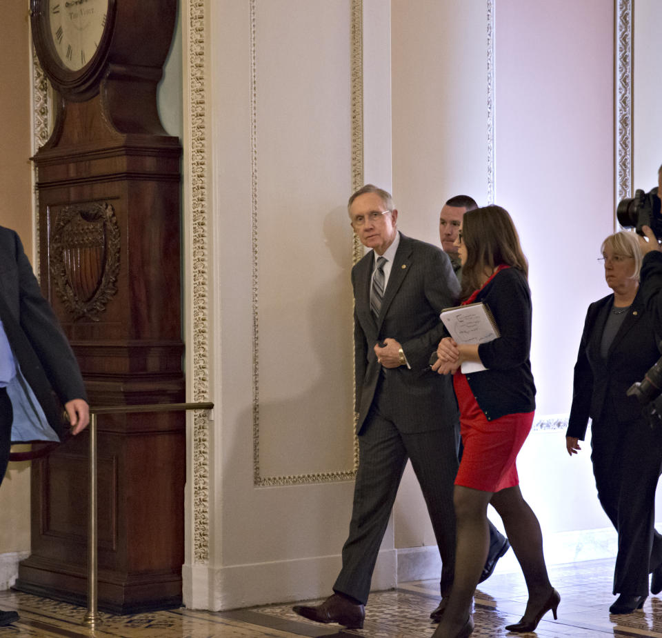 Senate Majority Leader Harry Reid, D-Nev., walks to the Senate floor following lunch with fellow Democrats, at the Capitol in Washington, Tuesday, Oct. 15, 2013. (AP Photo/J. Scott Applewhite)
