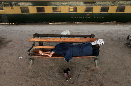 A man sleeps on a bench at Cantonment railway station, once a stop on the now disused Karachi Circular Railway line, in Karachi, Pakistan, May 23, 2017. REUTERS/Caren Firouz