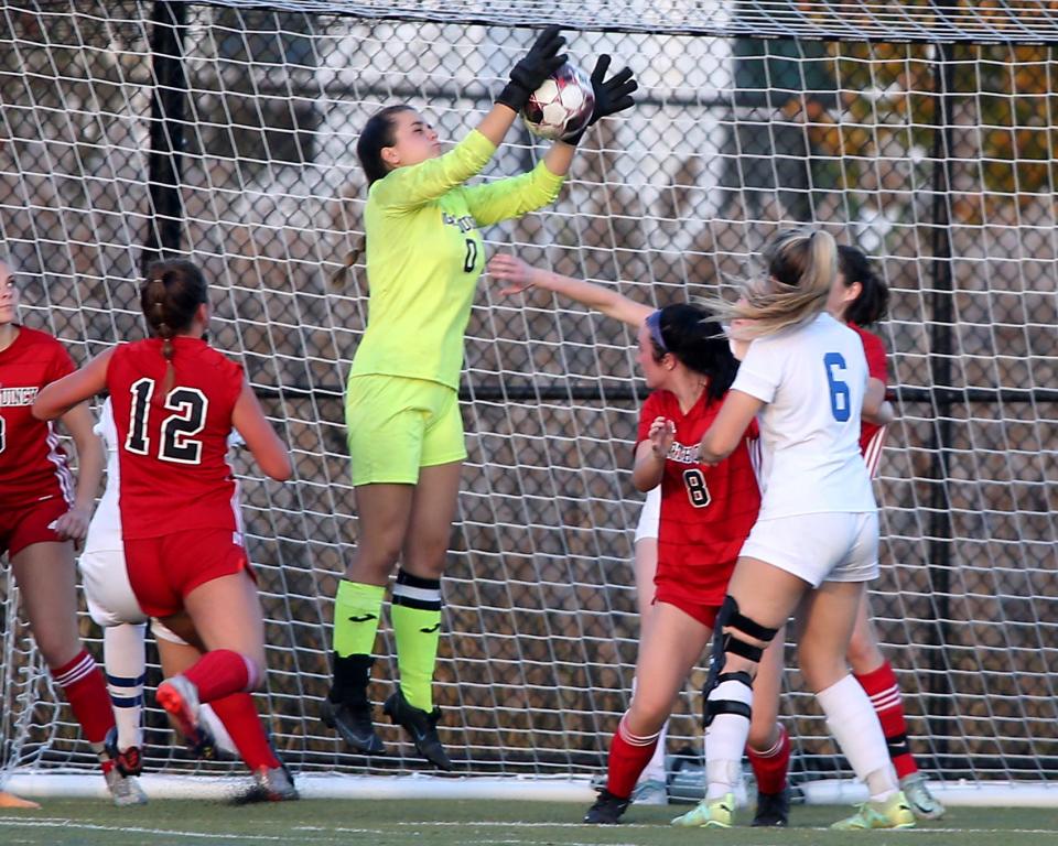 North Quincy goalie Lucy McLaughlin gathers in the ball to snuff out a Scituate corner kick during second half action of their game at Creedon Field in North Quincy on Thursday, Oct. 26, 2023. Scituate would go on to win 2-1.